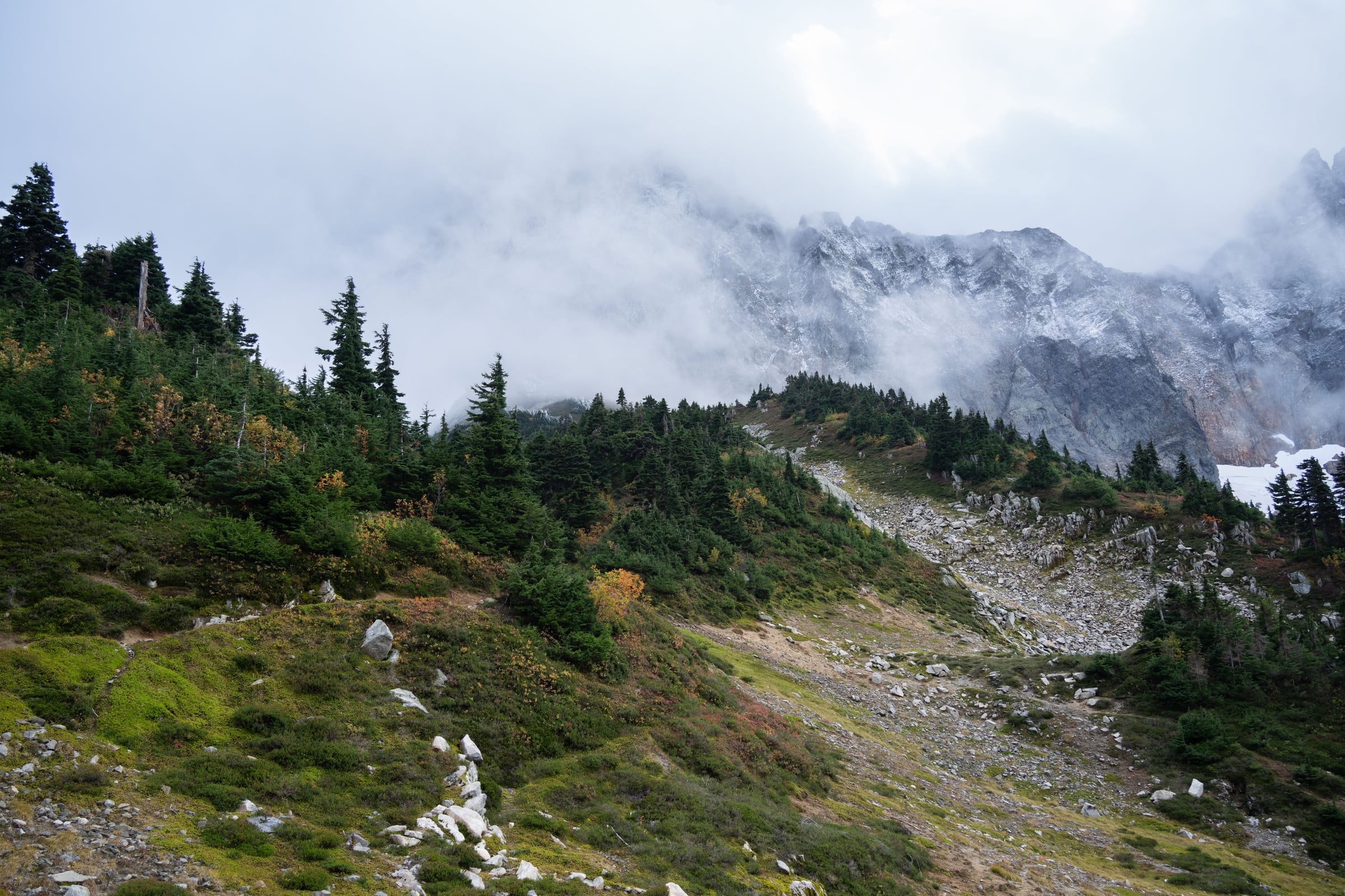 Misty alpine basin and rugged mountain ridge in Washington's North Cascades